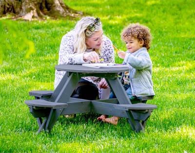 Jack and June Kids Circular Cedar Picnic Table - Adult sitting with kid at circular cedar picnic table